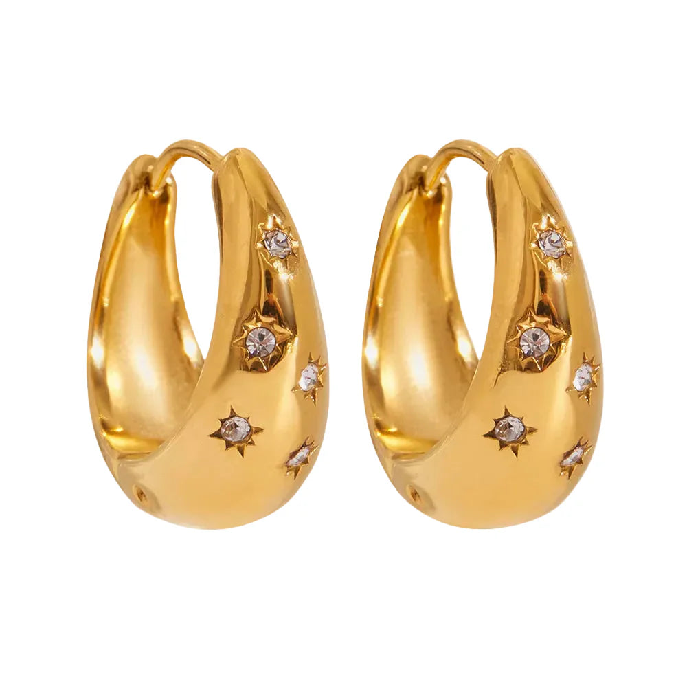 Gold hoop earrings with embedded diamonds on a white background