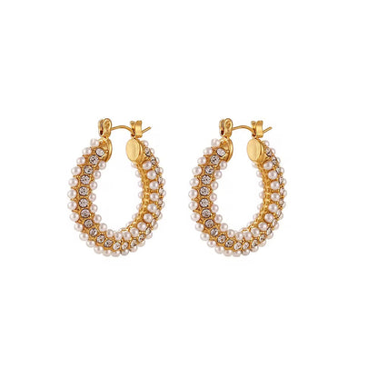 Gold hoop earrings with pearl and crystal detailing on a white background