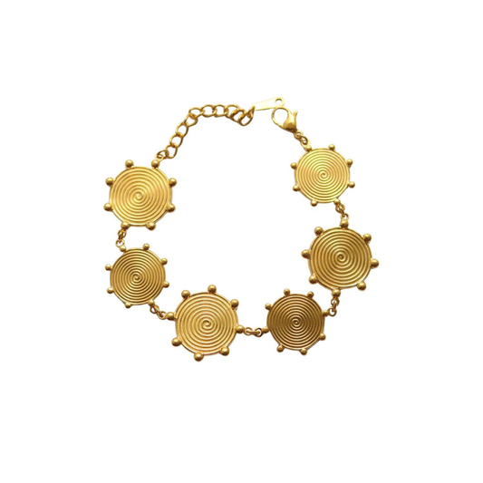 Gold bracelet with circular designs on a white background