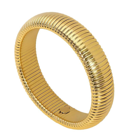 Gold bracelet with ribbed design on a white background