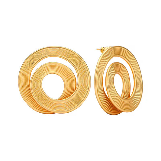 Pair of gold spiral hoop earrings on a white background