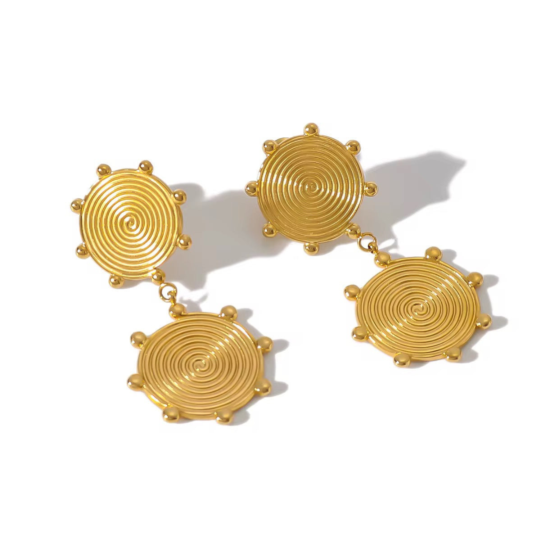 herae Gold spiral earrings on a white background