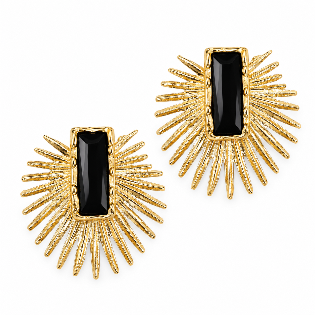 A pair of gold sunburst stud earrings with rectangular black onyx centers, shown on a clean white background.