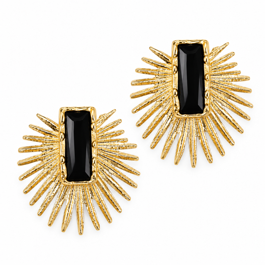 A pair of gold sunburst stud earrings with rectangular black onyx centers, shown on a clean white background.