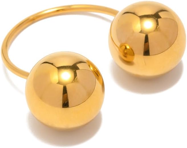 Gold ring with two spherical ends on a white background